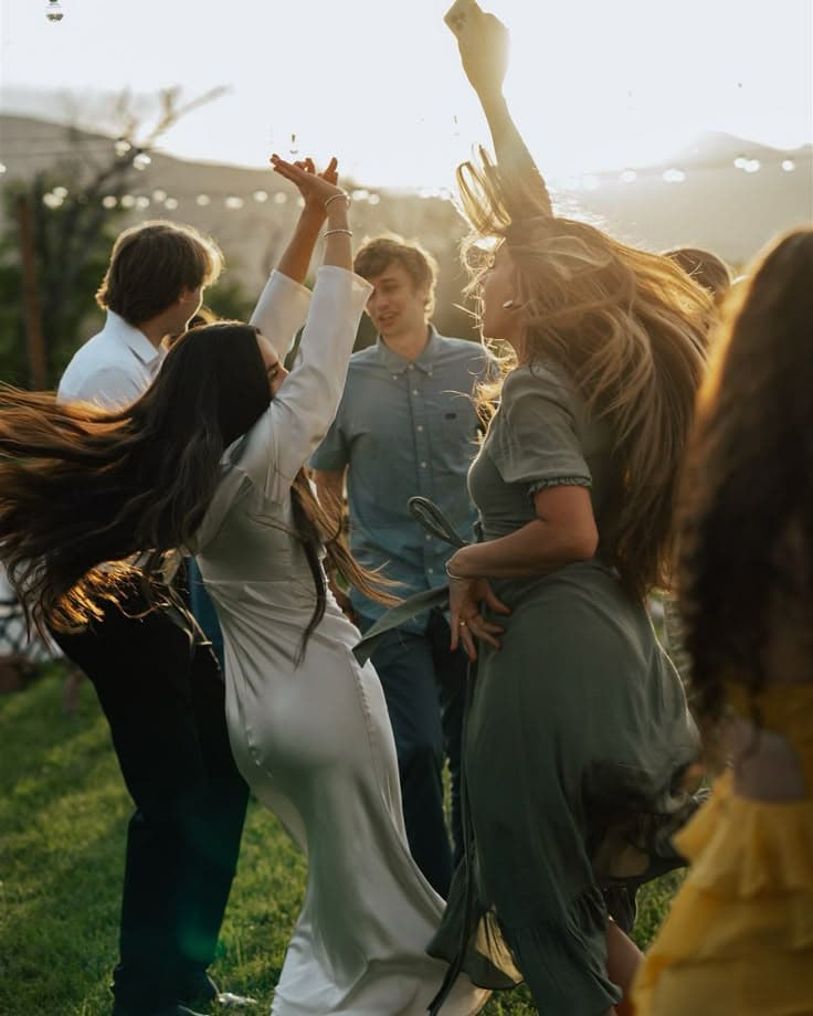 Guests dancing at sunset